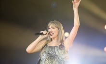 Taylor Swift performing in a sparkly dress.