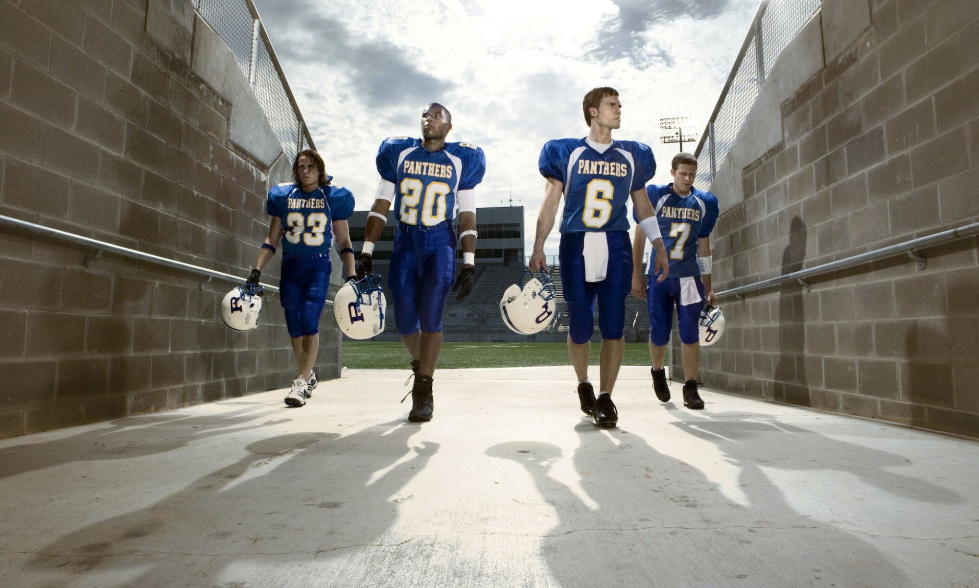 A football team walks off the field.