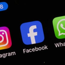 Instagram, Facebook, and WhatsApp icons on a smartphone screen