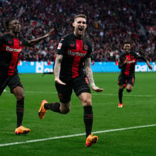 Leverkusen's Josip Stanisic, Odilon Kossounou and goalscorer Robert Andrich celebrate