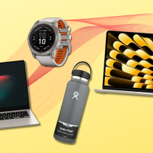 Samsung Galaxy Book, Hydro Flask bottle, Garmin watch, and MacBook Air with yellow and red background