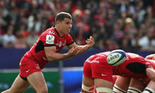 Antoine Dupont of Toulouse passes the ball