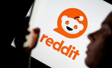 The Reddit logo is visible in the background, while the silhouette of a woman using a smartphone can be seen in the foreground.