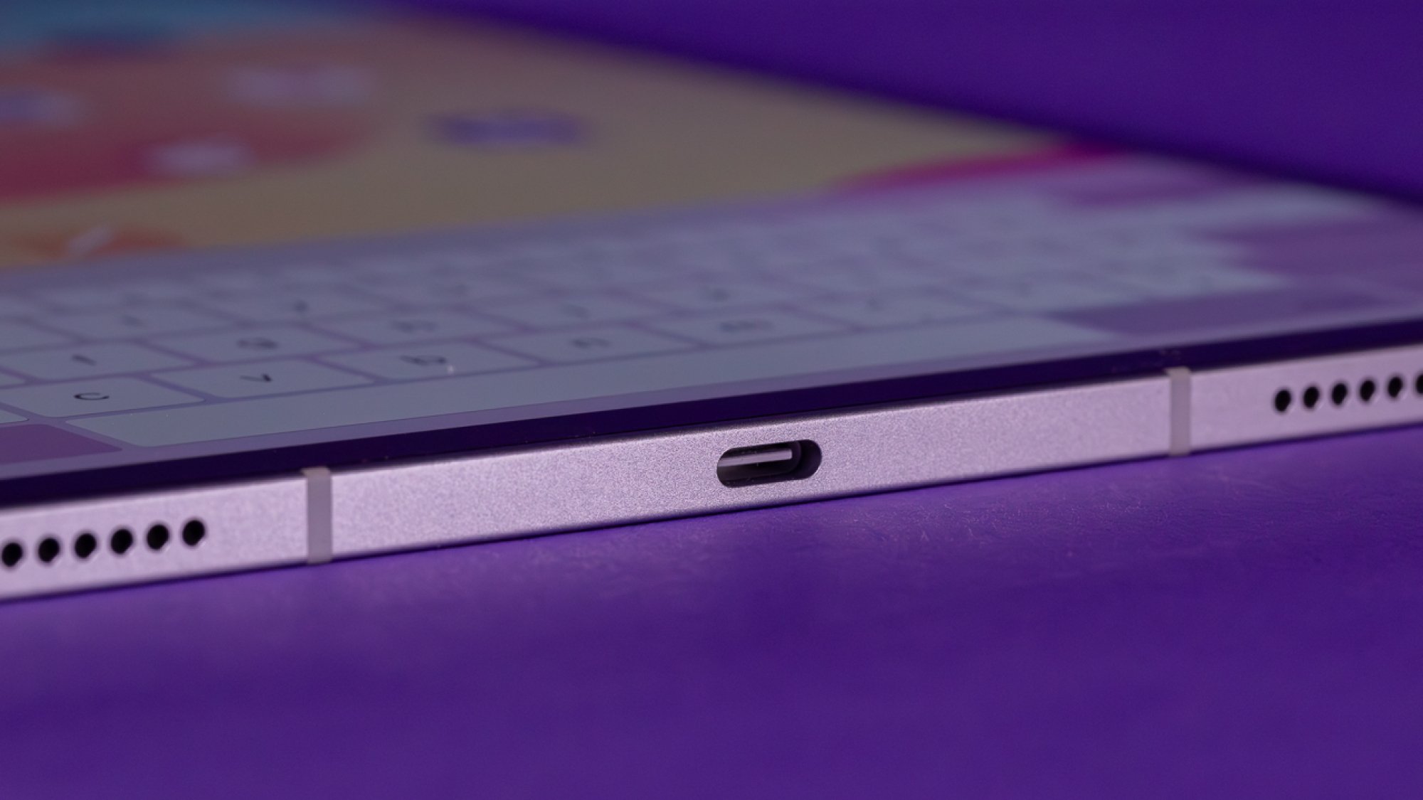 iPad Air USB-C port against purple background