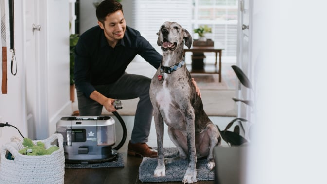 man with dog and BarkBath vacuum