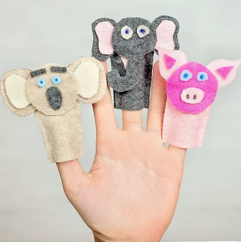 a hand wears three diy felt animal finger puppets the project is a good housekeeping pick for best activities for kids