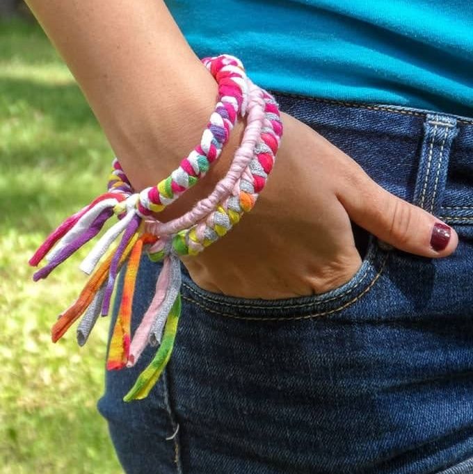 a woman wears bracelets from recycled t shirts