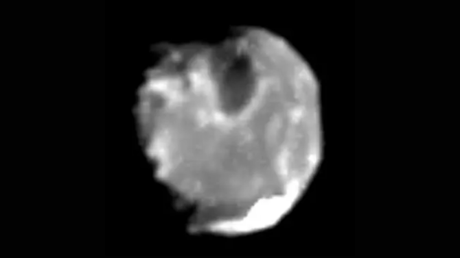 A blurry picture of a small, irregularly-shaped moon.