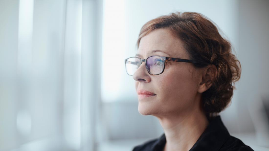 a woman looking pensive as she contemplates her polycystic ovary syndrome