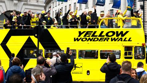Borussia Dortmund fans are seen on a double decker bus at Piccadilly Circus before the match
