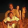 Yunjin Kim, Harold Perrineau, Malcolm David Kelley, and Sayid in Lost (2004)