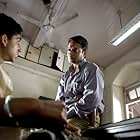 Irrfan Khan and Dev Patel in Slumdog Millionaire (2008)