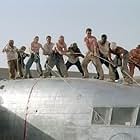The survivors of a downed aircraft pull together to build a new plane out of the wreckage of the old one.  (L to R) Jacob Vargas, Giovanni Ribisi, Miranda Otto, Hugh Laurie, Scott Michael Campbell, Kevork Malikyan, Dennis Quaid, Tyrese Gibson, Kirk Jones and Tony Curran. 