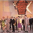 Maureen Arthur, Janice Carroll, Jeff DeBenning, Paul Hartman, Ruth Kobart, Michele Lee, Robert Morse, John Myhers, Kathryn Reynolds, Sammy Smith, Anthony 'Scooter' Teague, Dan Tobin, Rudy Vallee, and Carol Worthington in How to Succeed in Business Without Really Trying (1967)