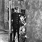 Charles Chaplin, Jackie Coogan, and Tom Wilson in The Kid (1921)