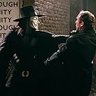Alister Mazzotti and Hugo Weaving in V for Vendetta (2005)