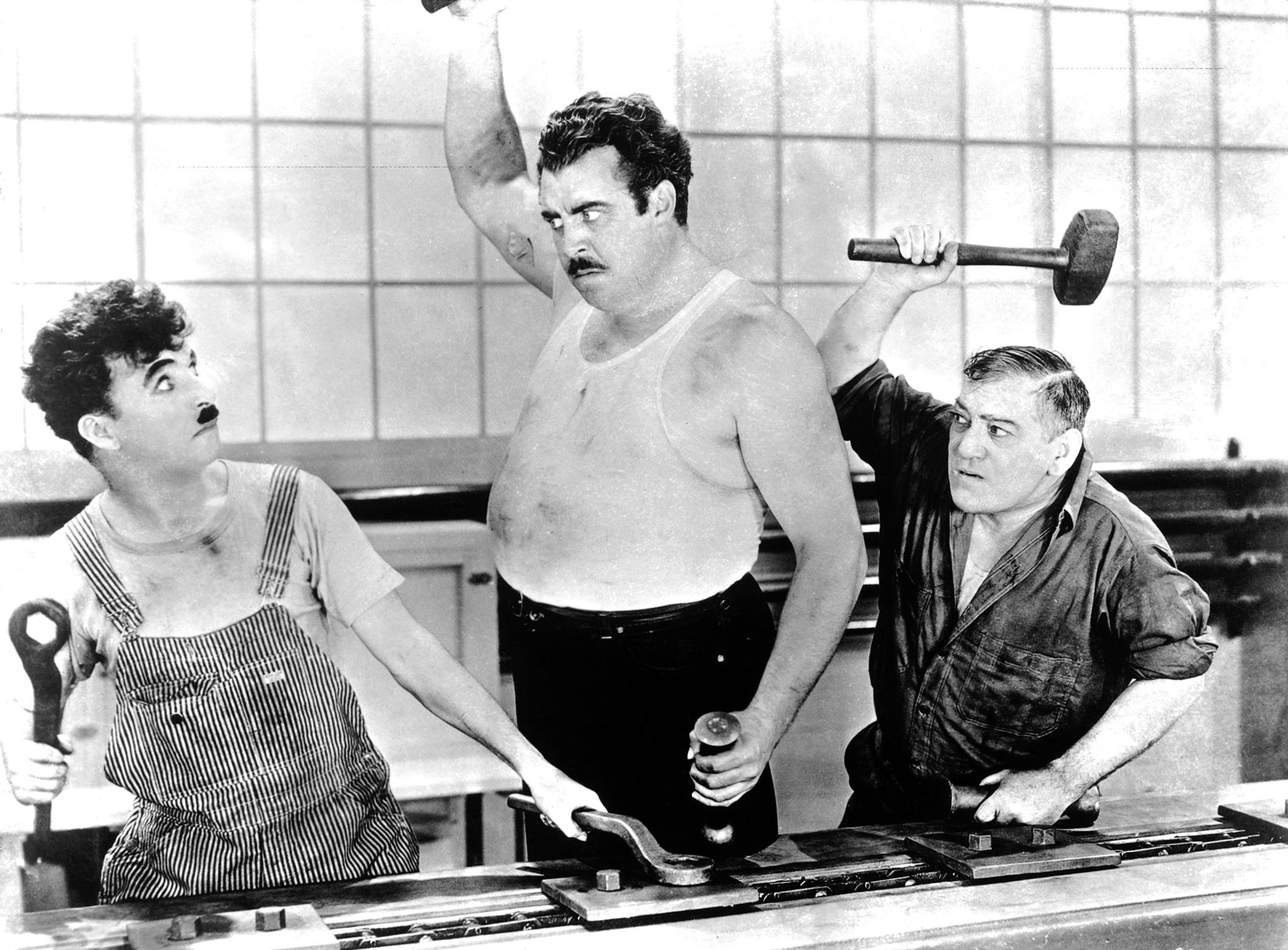 Charles Chaplin, Heinie Conklin, and Tiny Sandford in Modern Times (1936)