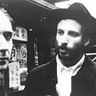 Renegade mathematician Max Cohen (Sean Gullette, left) and the leader of the Kabbalah sect, Lenny Meyer (Ben Shenkman) have a chance encounter on a Chinatown street corner.