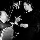 Alfred Hitchcock on the set of "Rope" with Joan Chandler, 1948.