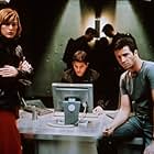 Milla Jovovich, Martin Crewes, and James Purefoy in Resident Evil (2002)