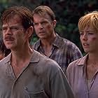 Téa Leoni, William H. Macy, Sam Neill, and Trevor Morgan in Jurassic Park III (2001)