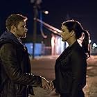 Kellan Lutz and Gina Carano in Extraction (2015)