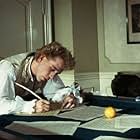 Mozart (TOM HULCE) composes music over a billiard table