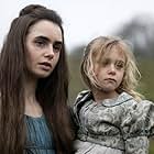 Mailow Defoy and Lily Collins in Les Misérables (2018)