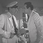 Jerome Cowan and Raymond Massey in The Hurricane (1937)
