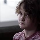 Tate Birchmore in Shattered, playing a schizophrenic child, jumping personalities at a moment's notice, a role for which he was nominated for Best Supporting Actor in a Feature Film by the Young Entertainer Awards