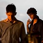 Dev Patel and Madhur Mittal in Slumdog Millionaire (2008)