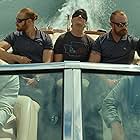 Chris Hemsworth, Mark Paguio, Miles Teller, and Daniel Reader in Spiderhead (2022)