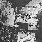 Edgar Barrier, Tom Brown, Cyril Delevanti, Marjorie Lord, Keye Luke, and Sidney Toler in The Adventures of Smilin' Jack (1943)