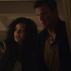 Nathan Fillion and Mekia Cox in The Overnight (2020)