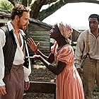Chiwetel Ejiofor, Michael Fassbender, and Lupita Nyong'o in 12 Years a Slave (2013)