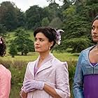 Shelley Conn, Charithra Chandran, and Simone Ashley in Harmony (2022)