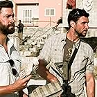 John Krasinski and Pablo Schreiber in 13 Hours: The Secret Soldiers of Benghazi (2016)