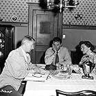 Robert Mitchum, John Cromwell, and Joyce Mackenzie in The Racket (1951)