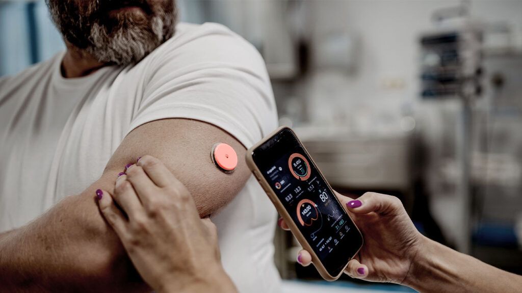 close-up of man's arm with blood glucose monitor