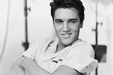 Elvis, leaning back, young and smiling