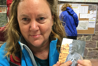 Tired woman holds pilgrim passport