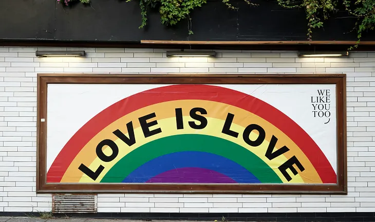 Sign in rainbows that says LOVE IS LOVE
