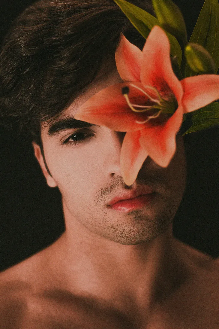 beautiful sultry man with flower