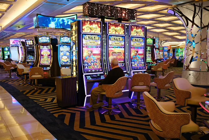 Elderly man plays a slot machine at a casino