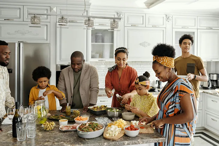 a family of different generations are cooking together in the kitchen