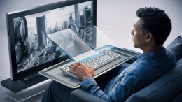 A cutting-edge 3D render of a man seated on a sofa, intently watching a large high-definition TV. On his lap, he holds a sleek, transparent computer keyboard that seemingly hovers above a metallic tray. With a few keystrokes, he can control the content on the screen, which displays a futuristic cityscape. The overall atmosphere of the image exudes advanced technology and seamless integration of digital and physical elements., 3d render