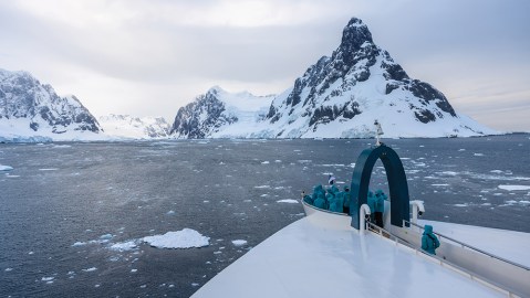 Passengers aboard the SH Minerva gaze from the “Swan’s Nest” as the ship approaches the Lemaire Channel, famed for its icebergs and sheer cliffs.