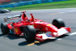 Ferrari driver Michael Schumacher raises a fist in victory after winning the 2002 German Grand Prix.