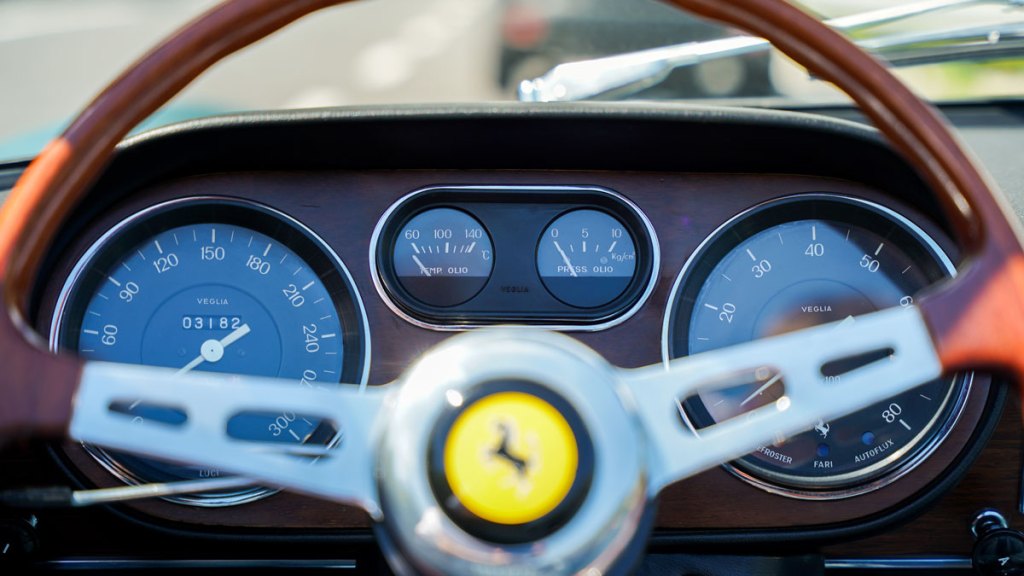 The steering wheel and dashboard of a 1965 Ferrari 275 GTS.