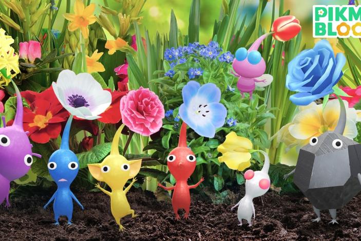 Seven Pikmin — Purple, Blue, Yellow, Red, White, Pink (flying) and Rock — are pictured standing in grass among flowers
